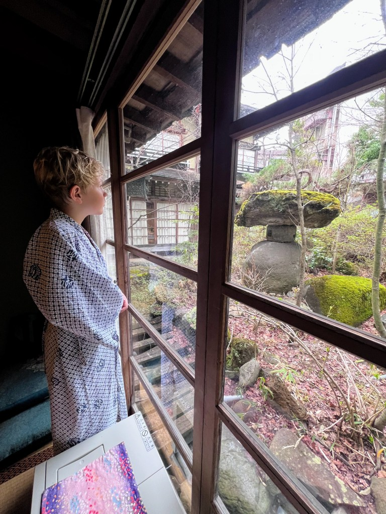 Traditional Japanese ryokan room with tatami floor and futon at Lakeland Hotel Mizunosato